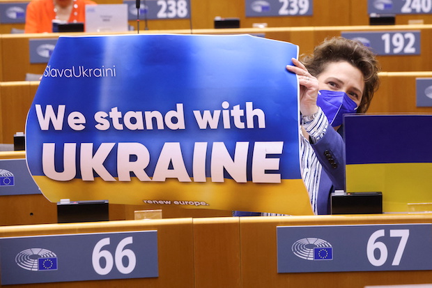 EU lawmakers, many wearing #standwithUkraine T-shirts bearing the Ukrainian flag, others with blue-and-yellow scarves or ribbons, gave Zelenskiy a standing ovation as he addressed the European Parliament via video link.