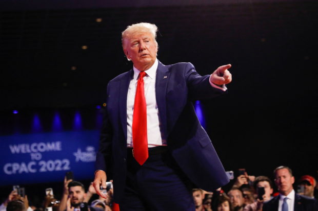 FILE PHOTO: Former U.S. President Donald Trump points out to supporters as he leaves the stage after speaking during the Conservative Political Action Conference (CPAC) in Orlando, Florida, U.S. February 26, 2022. REUTERS/Marco Bello