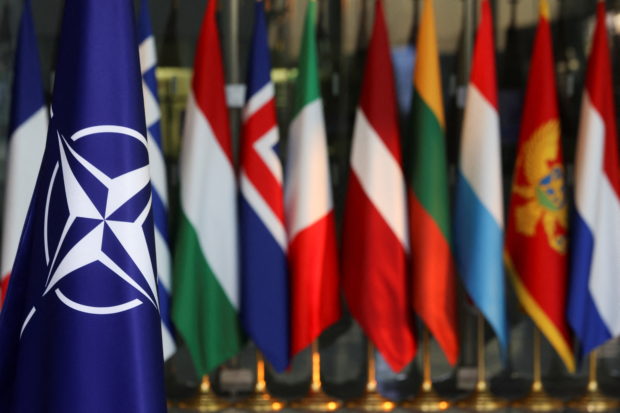 National flags of members of the NATO are seen, on the day of a foreign ministers meeting amid Russia's invasion of Ukraine, at the Alliance's headquarters in Brussels, Belgium March 4, 2022. REUTERS/Yves Herman