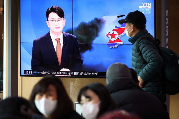 People watch a TV broadcasting a news report on North Korea's firing a ballistic missile off its east coast, in Seoul, South Korea, March 5, 2022.   REUTERS/Kim Hong-Ji