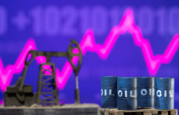 Models of oil barrels and a pump jack are displayed in front of a rising stock graph and "$100" in this illustration taken February 24, 2022. REUTERS/Dado Ruvic/Illustration/File Photo