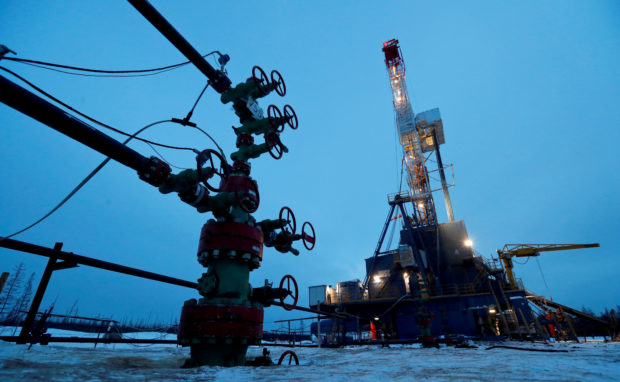 FILE PHOTO: A well head and drilling rig in the Yarakta oilfield, owned by Irkutsk Oil Company (INK), in the Irkutsk region, Russia, March 11, 2019. REUTERS/Vasily Fedosenko