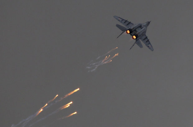 FILE PHOTO: A Polish Air Force MiG-29 aircraft fires flares during a performance at the Radom Air Show at an airport in Radom August 24, 2013. REUTERS/Kacper Pempel/File Photo