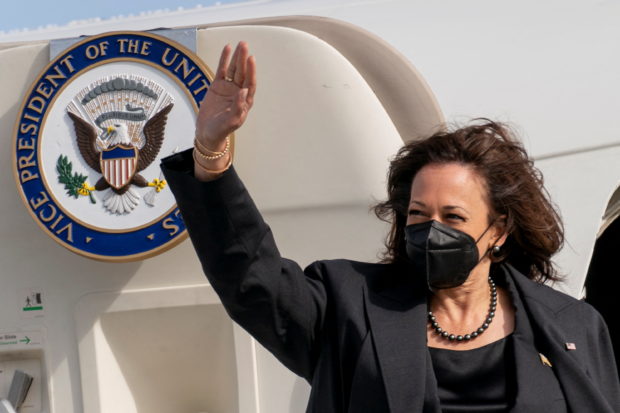 FILE PHOTO: U.S. Vice President Kamala Harris waves as she boards her airplane, to travel back to Washington after attending the Munich Security Conference, at Munich International Airport in Munich, Germany February 20, 2022. Andrew Harnik/Pool via REUTERS