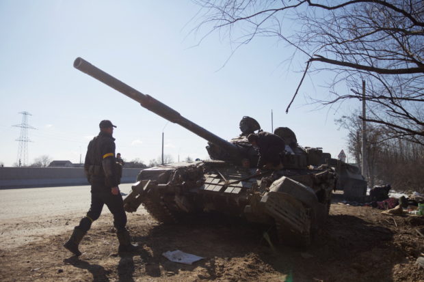 Members of the Ukrainian military are seen near a tank, amid Russia's invasion in Ukraine, near Kyiv, Ukraine March 10, 2022. Picture taken March 10, 2022. REUTERS/Anna Kudriavtseva
