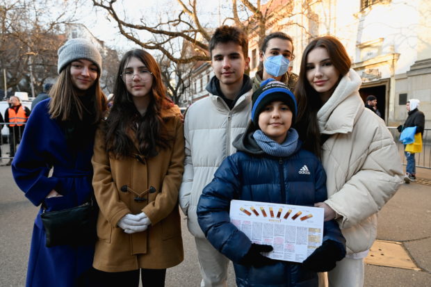 Hassan Alkhalaf, 11, who has escaped from Ukraine to Slovakia on his own, poses with his family members and his brother's girlfriend on the day of an anti-war rally, following Russia's invasion of Ukraine, in Bratislava, Slovakia, March 11, 2022. REUTERS/Radovan Stoklasa