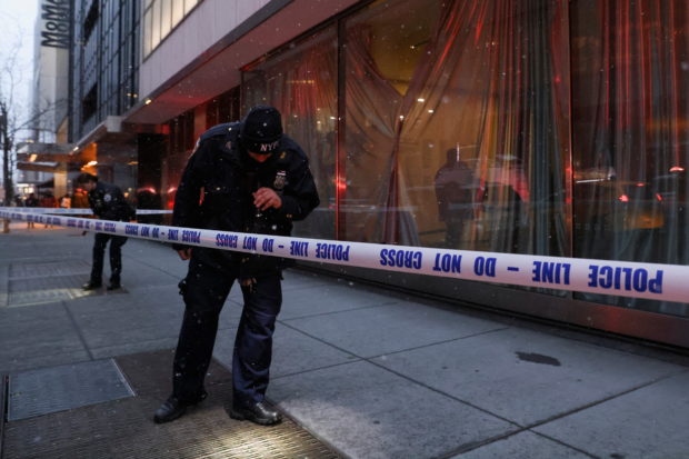 Members of the New York City Police Department (NYPD) search the area near the entrance of the Museum of Modern Art (MOMA) after an alleged multiple stabbing incident, in New York, U.S., March 12, 2022. REUTERS/Andrew Kelly
