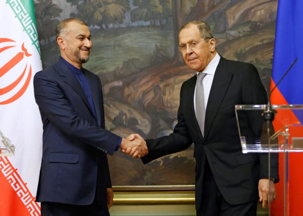Russian Foreign Minister Sergei Lavrov shakes hands with Iranian Foreign Minister Hossein Amir-Abdollahian during a joint news conference in Moscow, Russia March 15, 2022. REUTERS/Maxim Shemetov/Pool