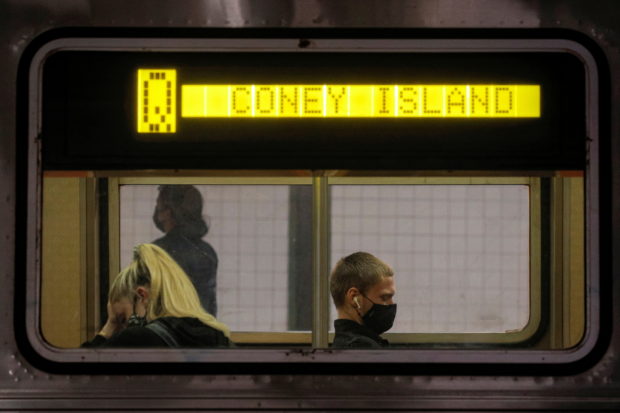 FILE PHOTO: Passengers ride aboard the MTA's New York City Transit subway, in New York, U.S., May 3, 2021.  REUTERS/Brendan McDermid/File Photo