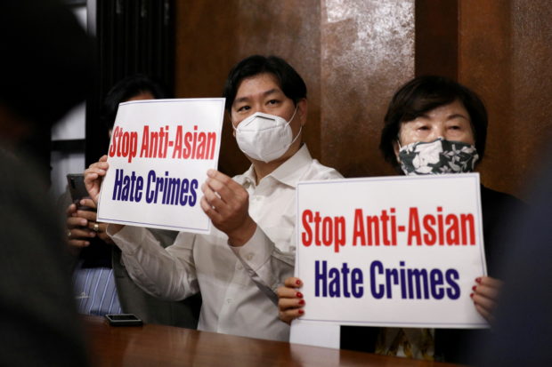 Members of the Atlanta Korean American Committee against Asian Hate Crime show placards as they meet at Ching Dam, a Korean restaurant, after the fatal shooting at three Georgia spas, in Duluth, Georgia, U.S., March 18, 2021. REUTERS/Dustin Chambers/File Photo