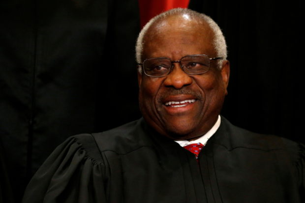 FILE PHOTO: U.S. Supreme Court Justice Clarence Thomas participates in taking a new "family photo" with his fellow justices at the Supreme Court building in Washington, D.C., U.S., June 1, 2017. REUTERS/Jonathan Ernst