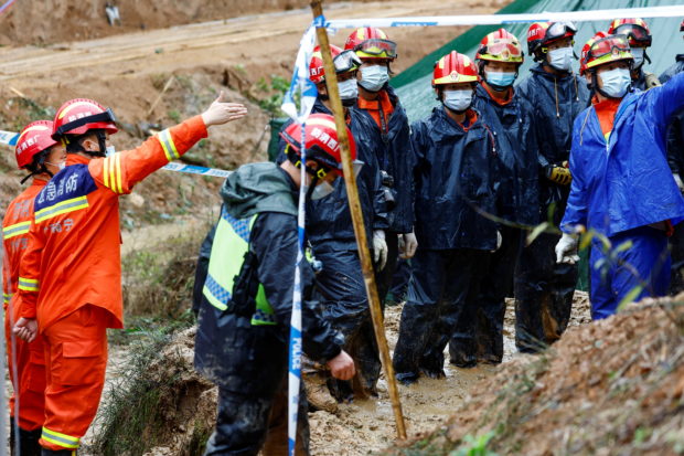 Rescue workers work at the site where a China Eastern Airlines Boeing 737-800 plane flying from Kunming to Guangzhou crashed, in Wuzhou, Guangxi Zhuang Autonomous Region, China March 24, 2022. REUTERS/Carlos Garcia Rawlins