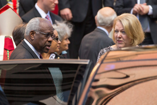 FILE PHOTO: U.S. Supreme Court Justice Clarence Thomas (L) and his wife Virginia Thomas (R) exit following the Red Mass, a service to mark the beginning of this year's Supreme Court term, at the Cathedral of St. Matthew the Apostle in Washington October 5, 2014. REUTERS/Jonathan Ernst/File Photo