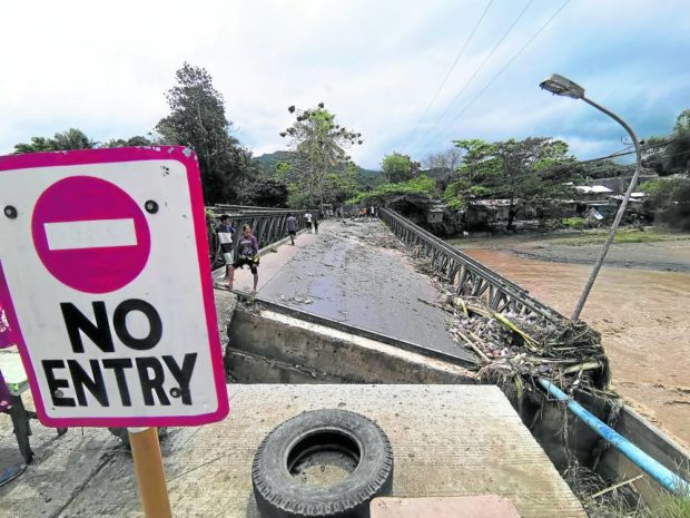 Collapsed steel bridge in Iligan City. STORY: 1,000 families flee homes as floods swamp Iligan City