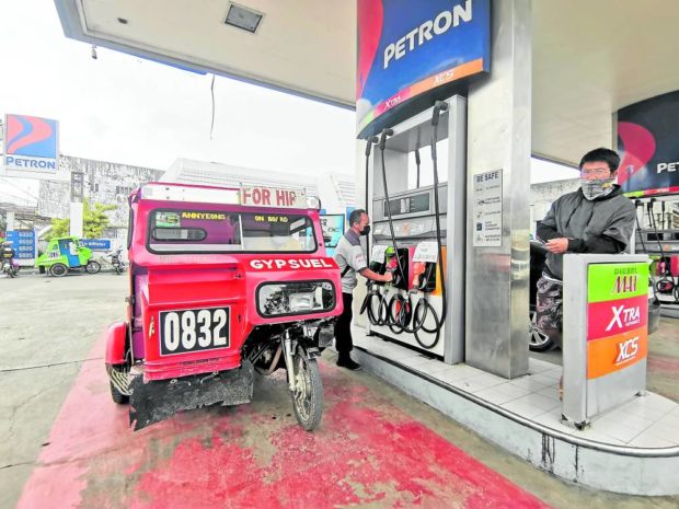 A tricycle at gas station in Tagbilaran City. STORY: West Visayas workers seek P100 wage hike