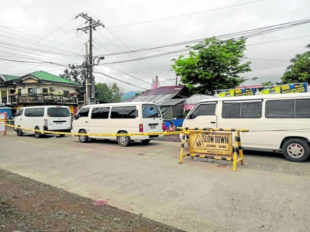 ILLEGAL SHIPMENT Police cordon off the three vans found loaded with packs of “shabu” (crystal meth) at a checkpoint in Infanta, Quezon, on Tuesday. —PHOTO COURTESY OF INFANTA VICE MAYOR LA Ruanto. STORY 3 vans carrying ‘shabu’ seized in Quezon town; 10 nabbed