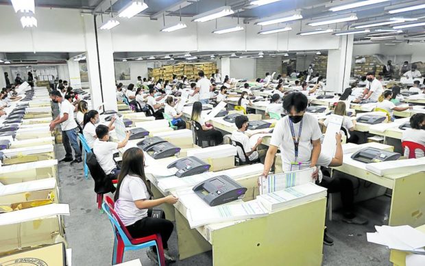 GOOD BALLOTS Workers at the National Printing Office in Quezon City check ballots for the May 9 polls to separate the “good ballots” from those that are defective. The Commission on Elections says 31,996,605, or 47.4 percent of 67,442,616 ballots needed, were approved for use in the national elections. —NIÑO JESUS ORBETA