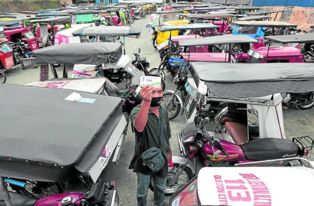 Tricycle driver with P500 fuel voucher. STORY: Gov’t eyes sale of cheaper fuel to PUVs – PNOC