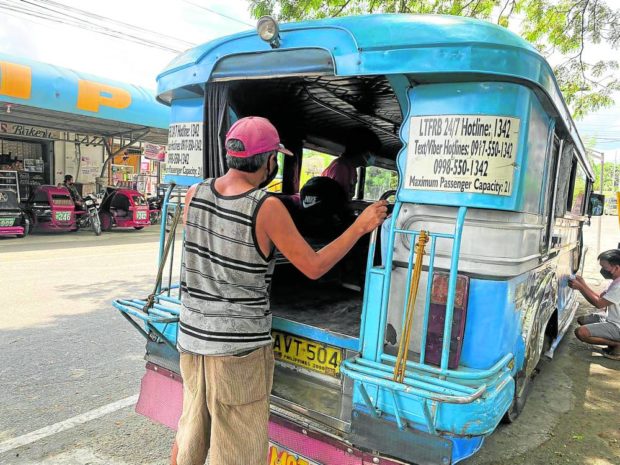 A jeepney driver waits for passengers heading to Laoag City in this photo taken Wednesday, March 16. Aside from the rising fuel prices, jeepney drivers and operators in the town are still reeling from lack of passengers despite eased COVID-19 protocols under alert level 1