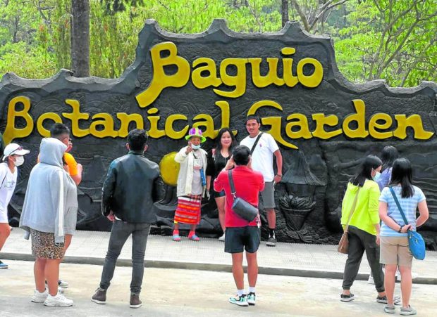 With tourists back, a group of elderly Cordillerans will get a chance to earn again as they pose with visitors for a small fee at the entrance of the newly rehabilitated Baguio Botanical Garden.
