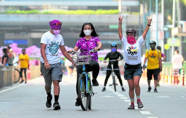 Bikers on Emerald Avenue in Pasig. STORY: Fuel price drop next week seen as temporary