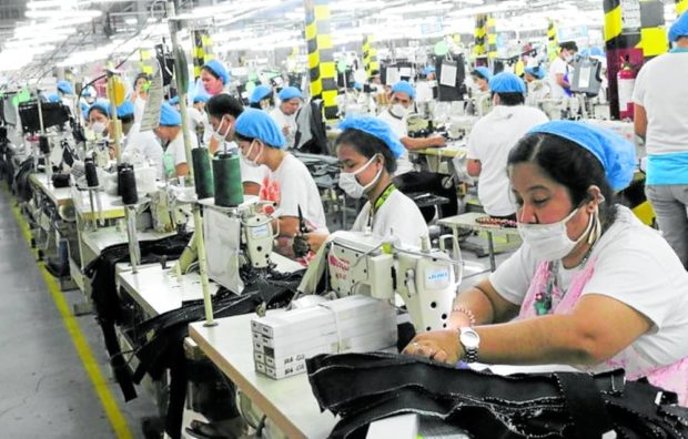 FACTORY JOB Garment makers at a clothes factory in Lapu-Lapu City, shown in this 2020 photo, will benefit once the government approves petitions for wage increase in Central Visayas. —Photo courtesy of the MEPZ Workers Alliance