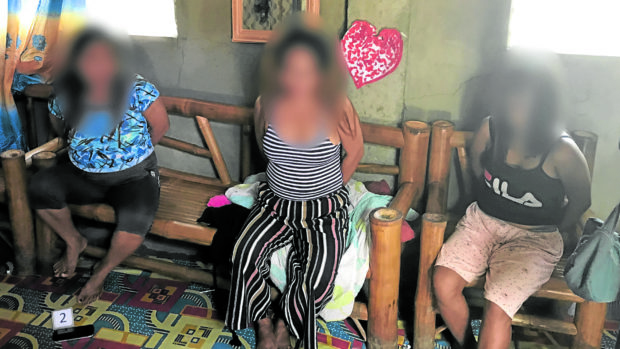 HANDCUFFED Three of the five women who were arrested for online sexual exploitation of children in Lapu-Lapu City were handcuffed after they were arrested by authorities as shown in this 2019 photo. STORY: 5 Cebu women get 15 years for online child exploitation