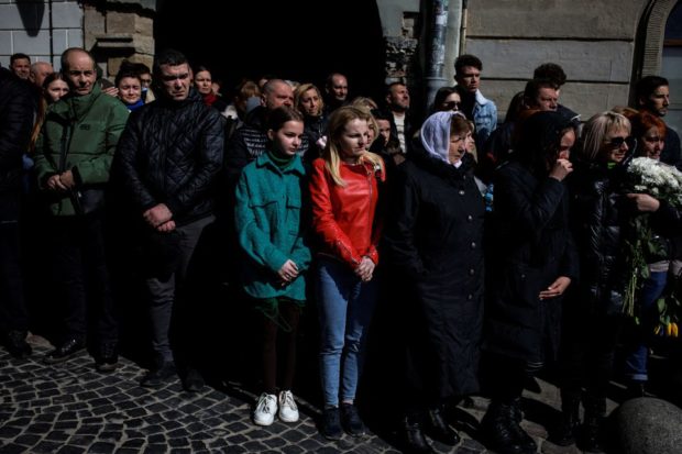 Ukrainian mourners ignore missile risks to attend military funerals