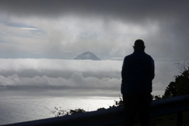 A person watches Pico island from Calheta
