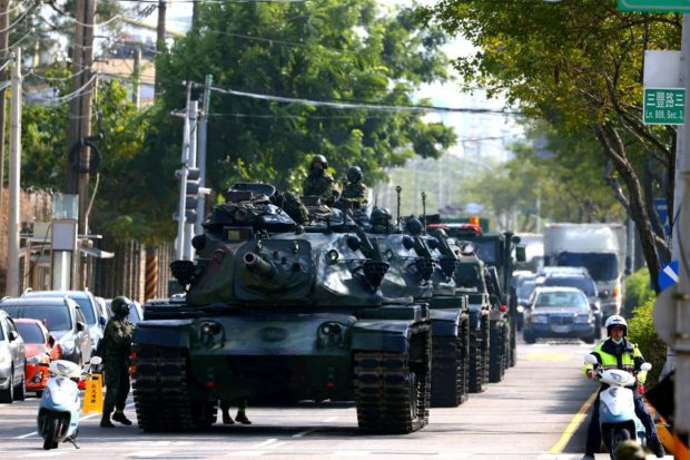 Soldiers drive M60 tanks on a street as part of a military drill in Taichung, Taiwan