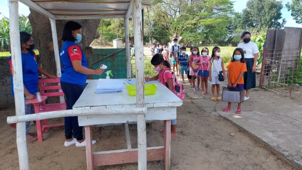 Pupils at an elementary school in Batac City, Ilocos Norte had their temperatures checked before entering the premises. (Photo courtesy of DepEd Batac City)