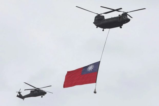 A Taiwan flag flews across the sky during National Day celebrations in Taipei, Taiwan