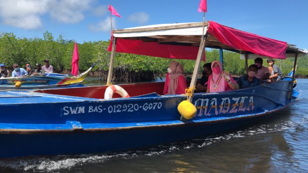Vice President Leni Robredo leaves Isabelan City's island village of Marang-Marang aboard a motorized banca. Robredo expressed her amazement at the villagers' efforts to protect the mangrove areas on the island