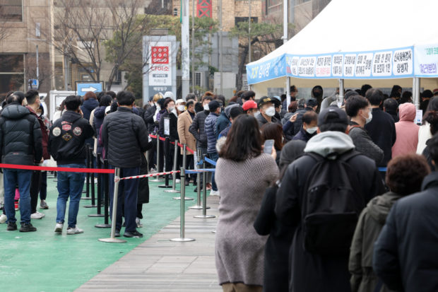 People line up for COVID-19 tests at a testing facility located in central Seoul