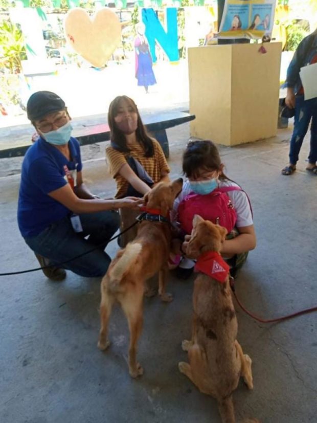 Kids playing with Aspins Chichi and Coffee at the vaccination center in North Fairview elem school.