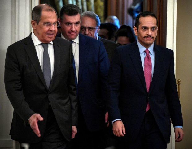 Russian Foreign Minister Sergei Lavrov walks with Qatari Foreign Minister Sheikh Mohammed bin Abdulrahman Al-Thani