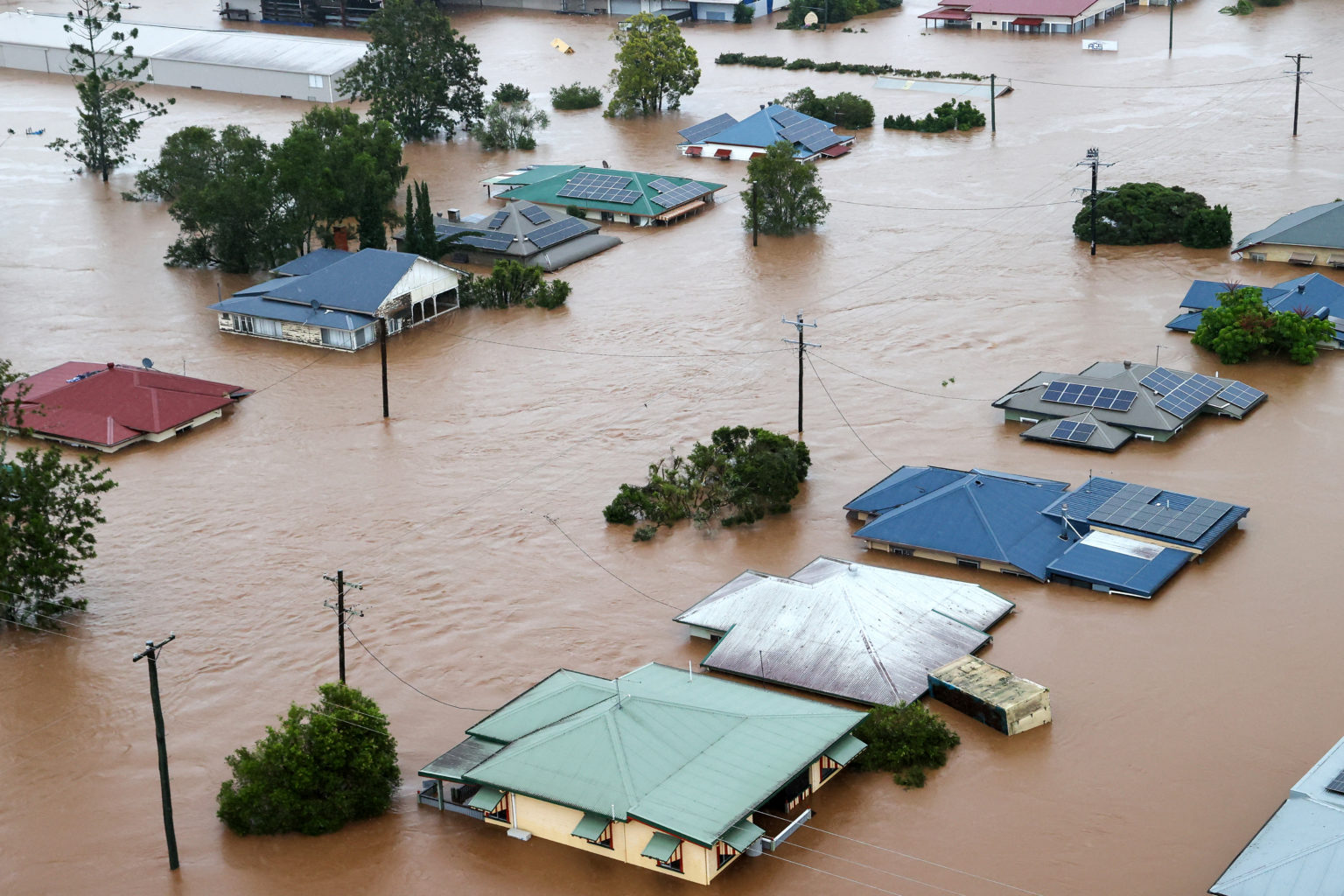 Australians rescued from rooftops as torrential rain ravages rural