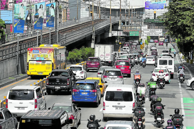 Shot of EDSA vehicles. STORY: Cities next to Manila asked to declare June 30 holiday