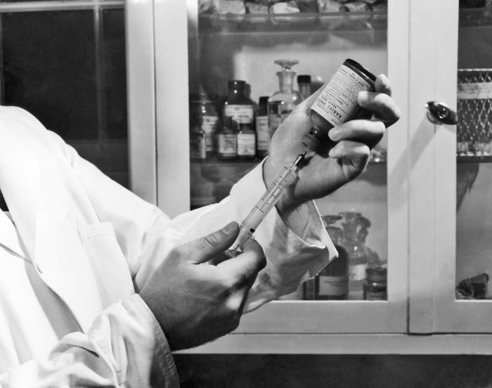 A historic photograph depicting a Centers for Disease Control (CDC) lab worker, as he was filling a syringe with rabies vaccine that had been obtained from the Alabama State Board of Health located in Montgomery, Alabama
