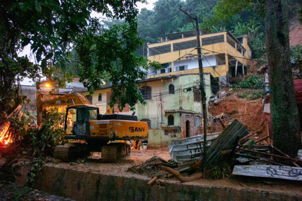 View of the site of a landslide in which a mother and six of her children were killed, in Paraty, Rio de Janeiro state, on April 2, 2022. - Torrential downpours triggered flash floods and landslides across Brazil's Rio de Janeiro state, killing at least 14 people including eight children, and leaving five missing, authorities said Saturday. (Photo by BRUNO KAIUCA / AFP)
