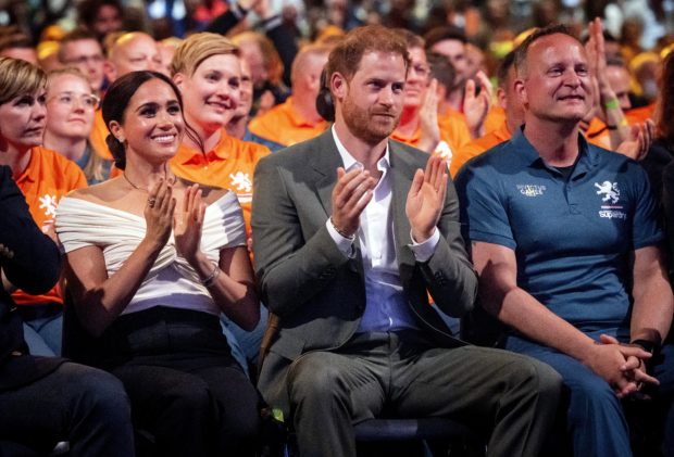 Britain's Duke of Sussex Prince Harry (C) and his wife Duchess of Sussex Meghan Markle, attend the opening ceremony of the Invictus Games in The Hague on April 16, 2022. - The Invictus Games is an international sporting event for servicemen and veterans who have been psychologically or physically injured in their military service. (Photo by Mischa Schoemaker / ANP / AFP) / Netherlands OUT
