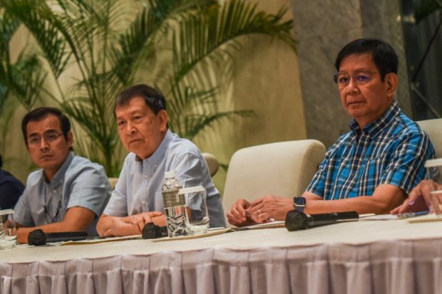(L-R) Philippine presidential bets Manila City Mayor Francisco Domagoso, known by his screen name Isko Moreno, former defence secretary Norberto Gonzales, and senator Panfilo Lacson hold a press conference at the Manila Peninsula Hotel in Makati City on April 17, 2022. STORY: 3 bets hit Robredo: Who gains? VP camp asks