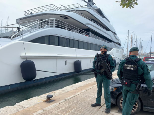 Spanish Civil Guards stand by the Tango superyacht, suspected to belong to a Russian oligarch, as it is docked at the Mallorca Royal Nautical Club, in Palma de Mallorca, in the Spanish island of Mallorca, Spain, April 4, 2022. Juan Poyates Oliver/Handout via REUTERS THIS IMAGE HAS BEEN SUPPLIED BY A THIRD PARTY. MANDATORY CREDIT.