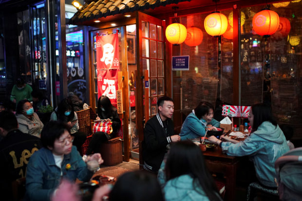FILE PHOTO: People dine at a restaurant in Beijing, China October 25, 2020. REUTERS/Tingshu Wang