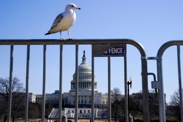 U.S. Capitol is seen through a barricade prior to the arrival of several different convoys of truckers and other protestors headed to Washington to protest coronavirus disease (COVID-19) related mandates and other issues, in Washington, U.S., March 5, 2022.   REUTERS/Shuran Huang