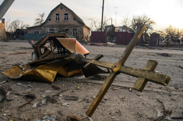 A cross and a destroyed dome of a local church damaged by shelling are seen on a road, as Russia's attack on Ukraine continues, in the settlement of Hostomel, outside Kyiv, Ukraine April 6, 2022.  REUTERS/Vladyslav Musiienko
