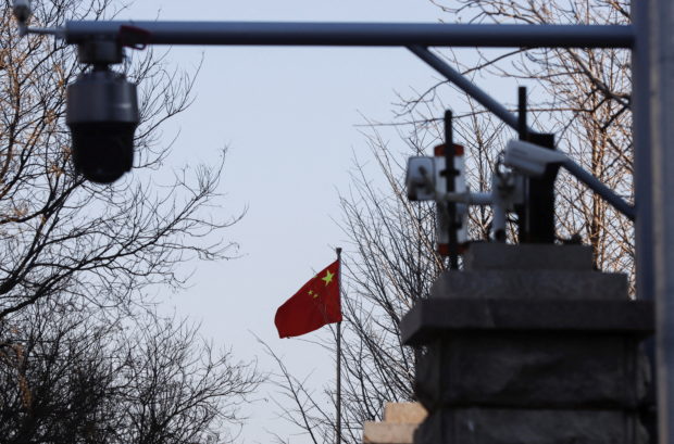 A Chinese flag is seen near surveillance cameras outside the Beijing No. 2 Intermediate People's Court, where Australian journalist Cheng Lei is expected to face trial on state secrets charges, in Beijing, China March 31, 2022. REUTERS/Florence Lo