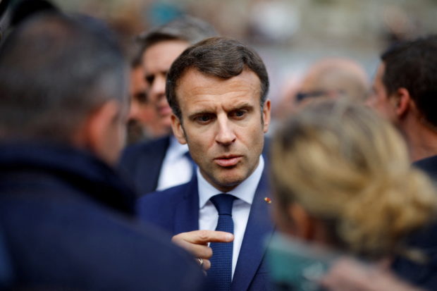 FILE PHOTO: French President Emmanuel Macron, candidate for his re-election in the 2022 French presidential election, speaks with supporters during a campaign trip in Spezet, France, Avril 5, 2022. REUTERS/Stephane Mahe/File Photo