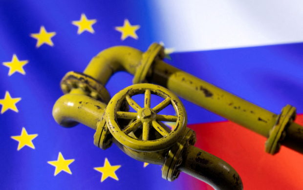 FILE PHOTO: A 3D printed Natural Gas Pipes are placed on displayed EU and Russian flags in this illustration taken, January 31, 2022. REUTERS/Dado Ruvic