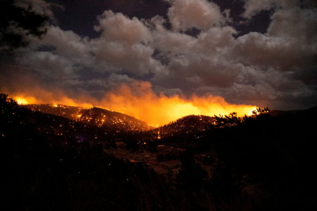 FILE PHOTO: The McBride Fire burns in the heart of the village in Ruidoso, New Mexico, United States, April 12, 2022. Ivan Pierre Aguirre/USA Today Network via REUTERS